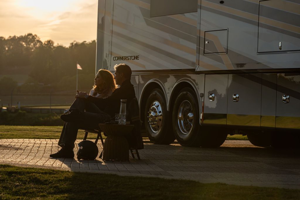 Couple seated outside the Cornerstone Series 6 in golden evening light